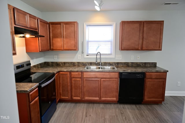 kitchen with black appliances, dark hardwood / wood-style flooring, and sink