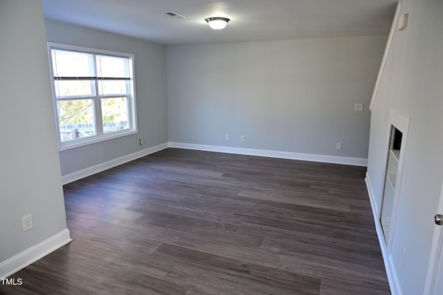 spare room featuring dark hardwood / wood-style flooring