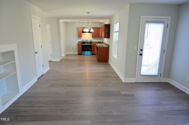 kitchen with sink, pendant lighting, a chandelier, hardwood / wood-style floors, and stainless steel electric range