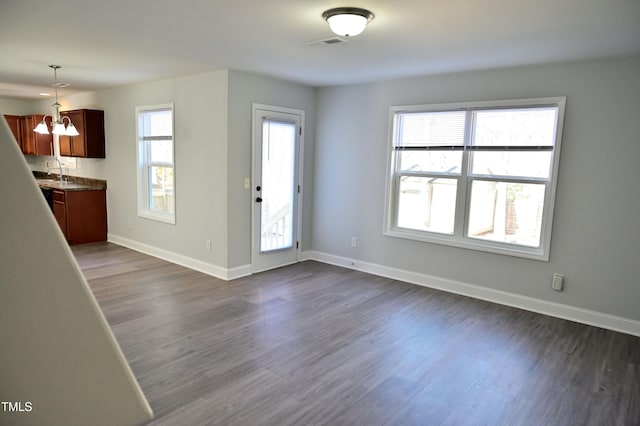 interior space featuring dark hardwood / wood-style floors, sink, and a chandelier