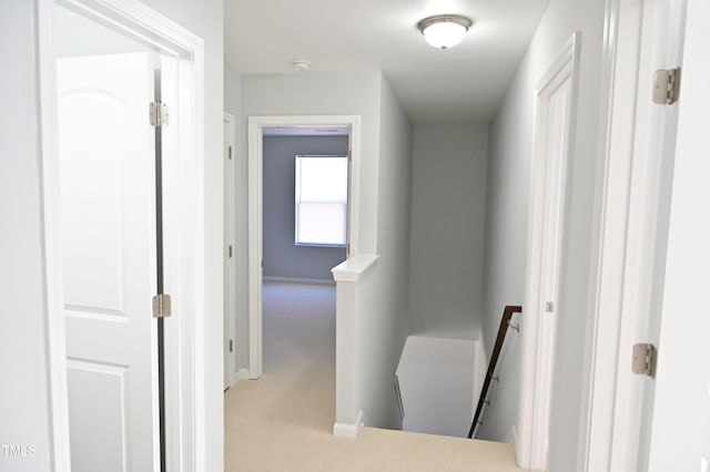 hall with light colored carpet