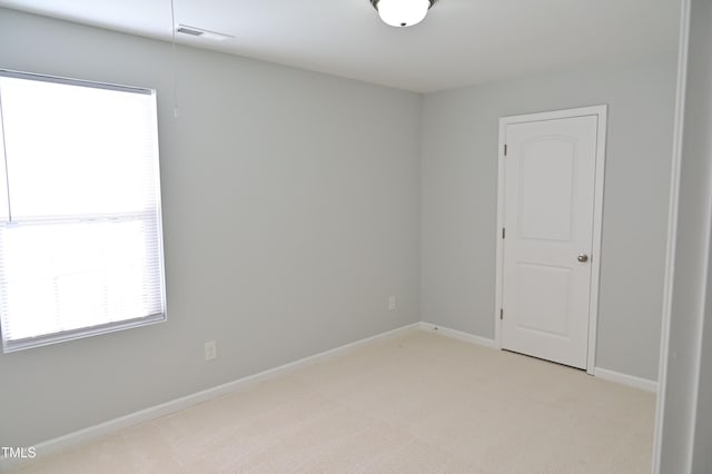 spare room with light carpet