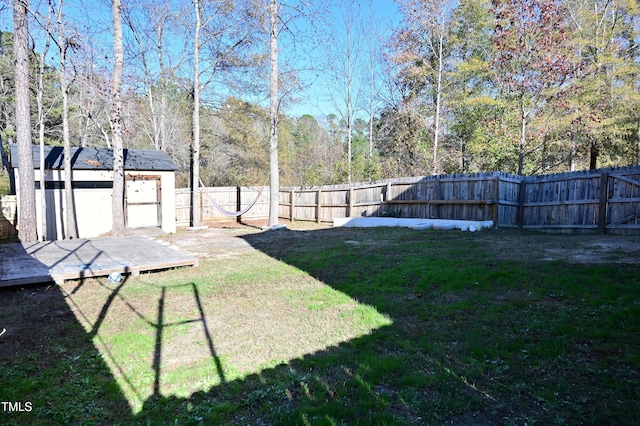 view of yard featuring a shed and a deck