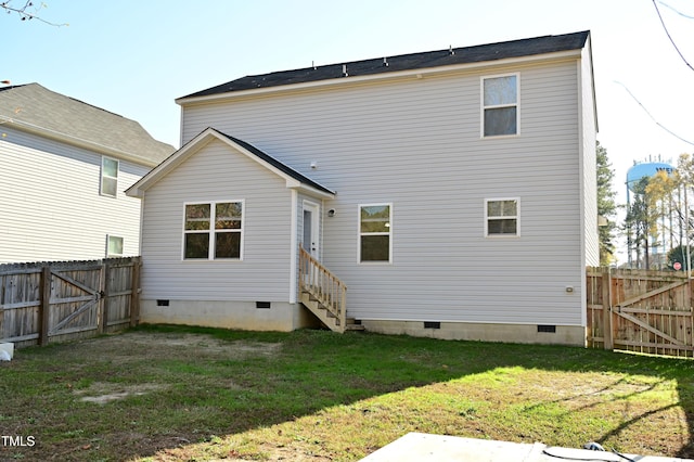 rear view of house featuring a lawn