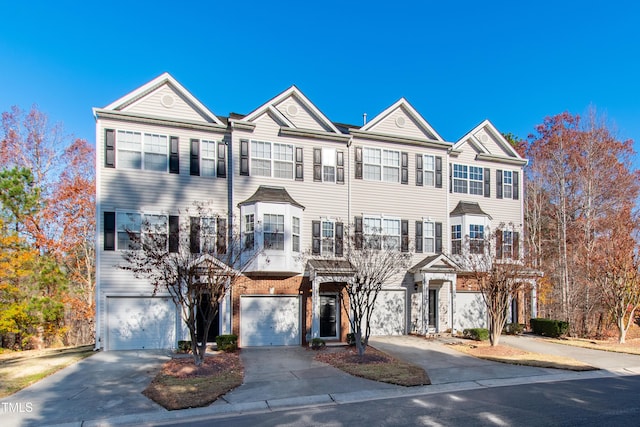 townhome / multi-family property featuring a garage