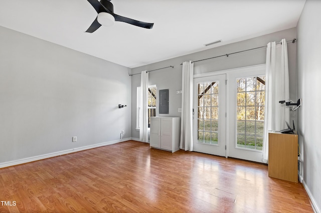 interior space with ceiling fan, light hardwood / wood-style floors, and electric panel