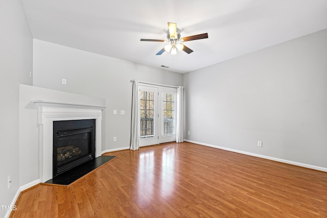 unfurnished living room with wood-type flooring and ceiling fan