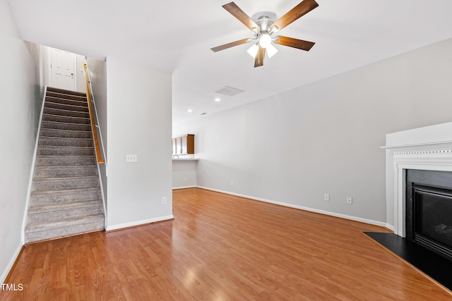 unfurnished living room with ceiling fan and light hardwood / wood-style floors