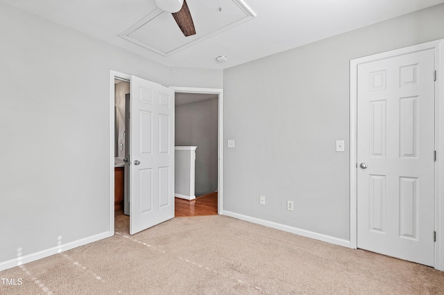 unfurnished bedroom featuring ceiling fan and light carpet