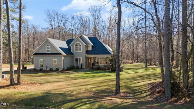 view of front facade featuring covered porch and a front yard