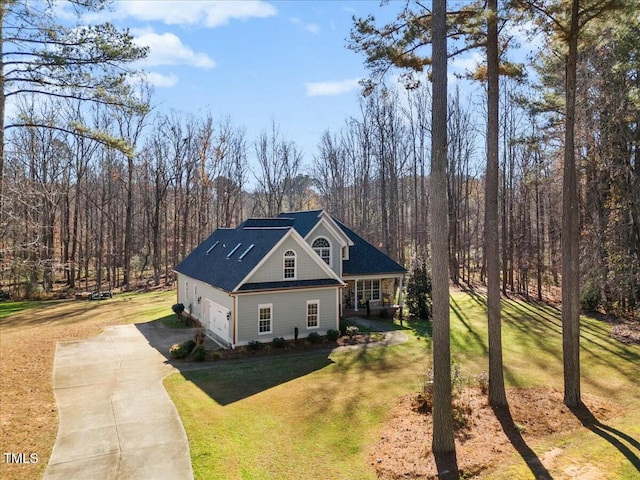 view of front of home with a garage and a front lawn