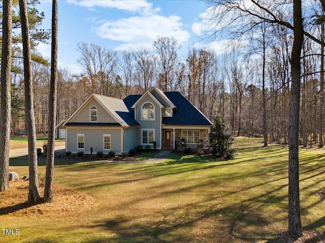 view of front of house featuring covered porch and a front yard