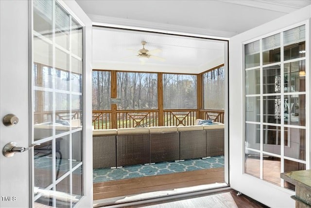 unfurnished sunroom with ceiling fan