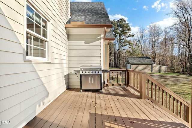 wooden deck with an outbuilding and a grill