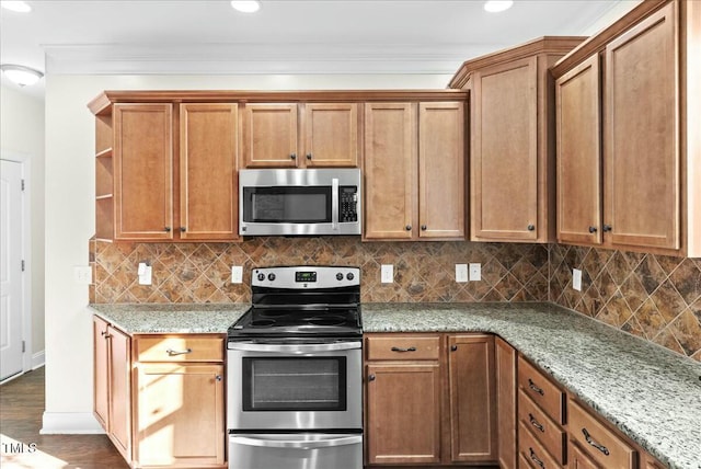 kitchen featuring light stone counters, backsplash, dark hardwood / wood-style flooring, and stainless steel appliances