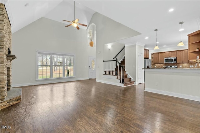 unfurnished living room with high vaulted ceiling, dark wood-type flooring, ceiling fan, and a fireplace