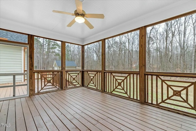 unfurnished sunroom with ceiling fan