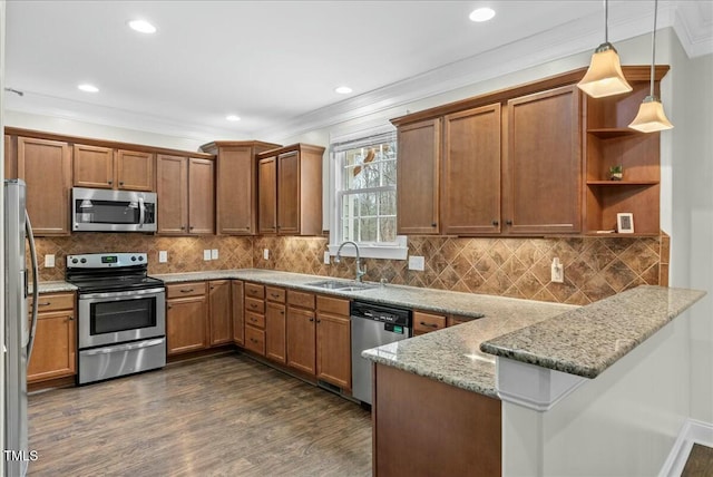 kitchen featuring hanging light fixtures, sink, kitchen peninsula, stainless steel appliances, and light stone counters