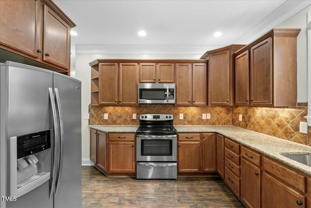 kitchen with light stone countertops, appliances with stainless steel finishes, dark hardwood / wood-style flooring, and crown molding