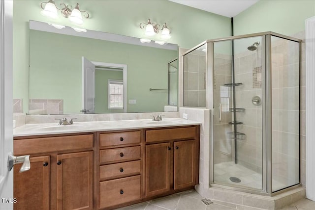 bathroom featuring vanity, a shower with shower door, and tile patterned floors