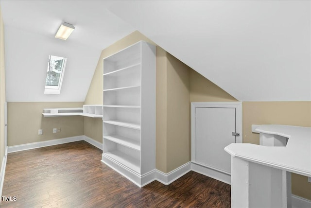 bonus room with lofted ceiling with skylight and dark hardwood / wood-style flooring