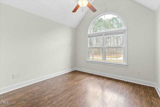 spare room with dark wood-type flooring, vaulted ceiling, and ceiling fan