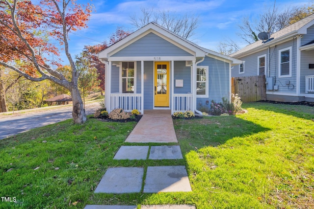 bungalow featuring a front lawn and a porch