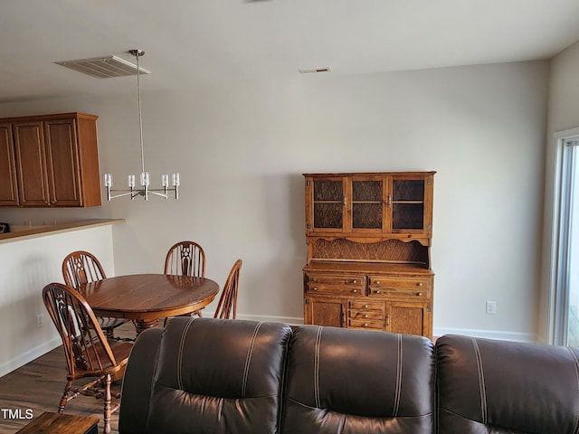 dining space with dark hardwood / wood-style flooring and a healthy amount of sunlight