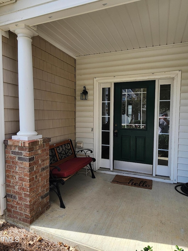 view of exterior entry with covered porch