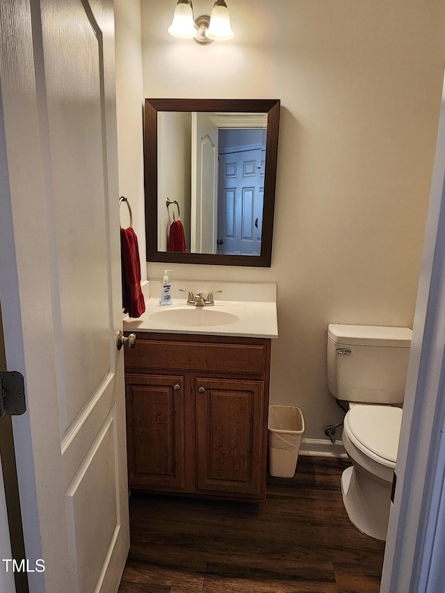 bathroom featuring hardwood / wood-style floors, vanity, and toilet