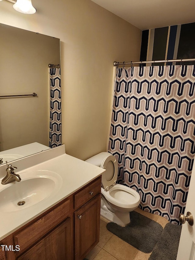 bathroom with tile patterned flooring, vanity, and toilet