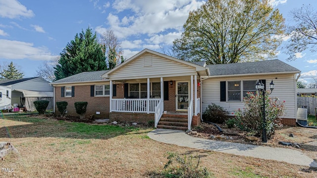 view of front of house with covered porch and a front lawn