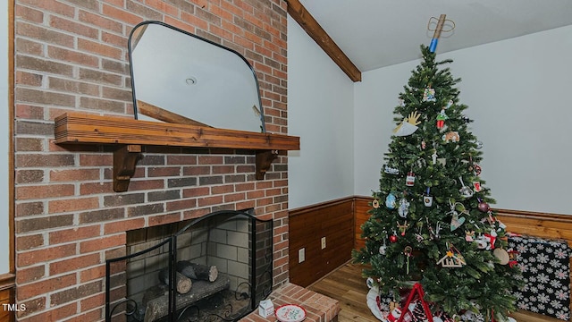 details featuring a fireplace, wood-type flooring, and beam ceiling