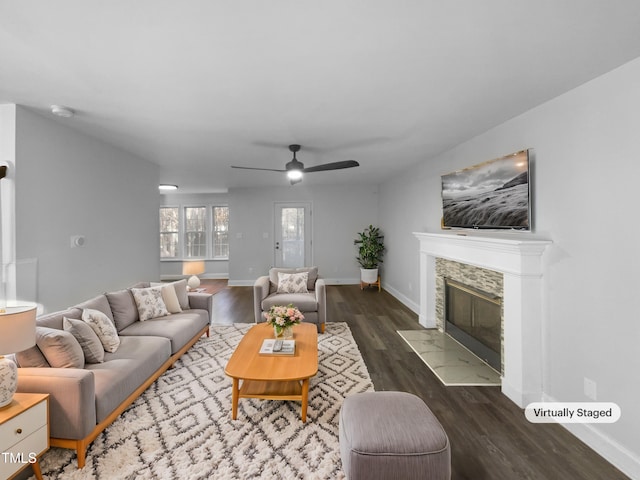 living room with a fireplace, dark hardwood / wood-style floors, and ceiling fan