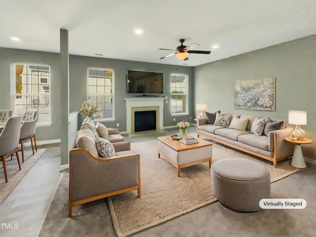 carpeted living room featuring ceiling fan and plenty of natural light