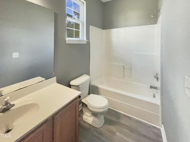 full bathroom with toilet, vanity, shower / bathtub combination, and hardwood / wood-style flooring