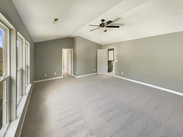 unfurnished bedroom featuring ceiling fan, lofted ceiling, and carpet floors