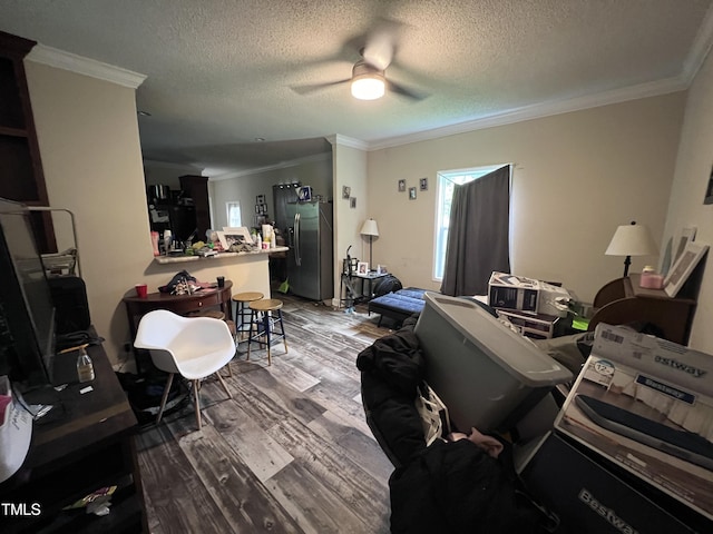 living room featuring ceiling fan, ornamental molding, and hardwood / wood-style flooring