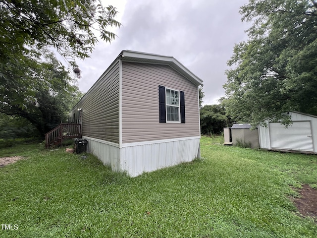 view of home's exterior featuring a storage shed and a lawn