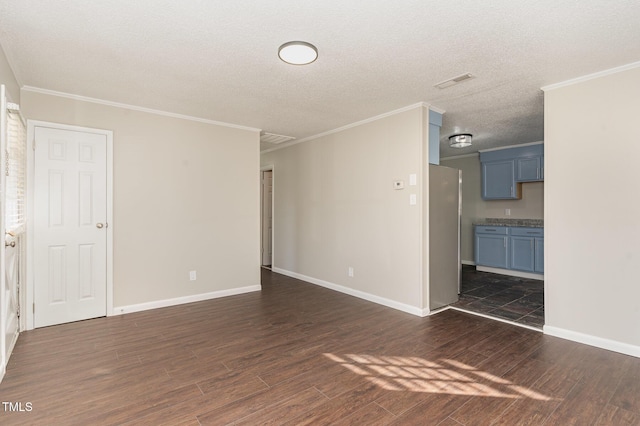 spare room featuring a textured ceiling, ornamental molding, and dark wood-type flooring