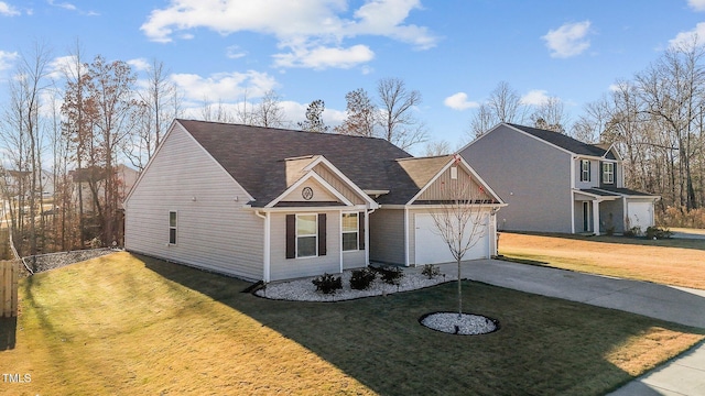 view of front of property featuring a garage and a front yard