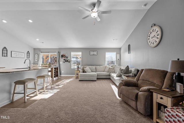 living room with light wood-type flooring, ceiling fan, and lofted ceiling