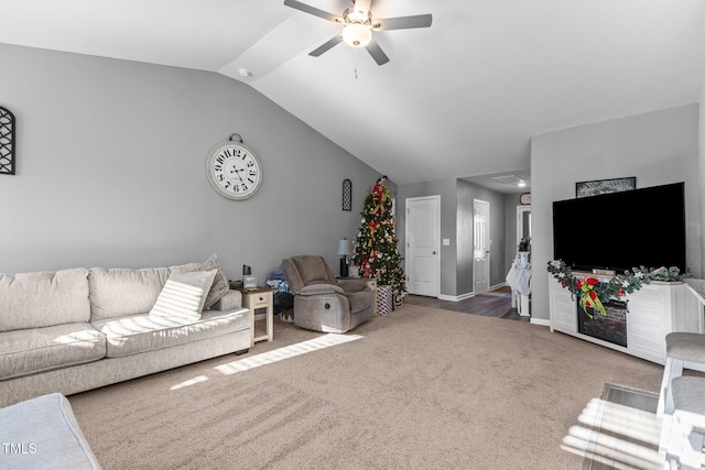 living room with ceiling fan, carpet floors, and lofted ceiling