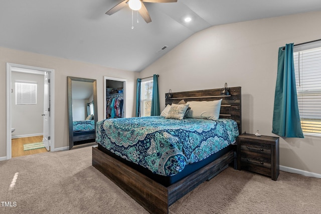 carpeted bedroom with multiple windows, a spacious closet, a closet, and ceiling fan