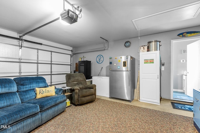 garage featuring stainless steel refrigerator, a garage door opener, and fridge