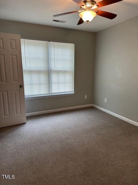 unfurnished room with carpet flooring and ceiling fan