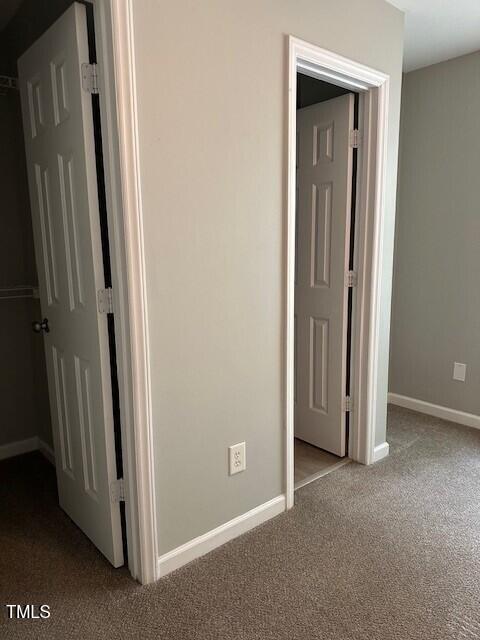 corridor featuring light colored carpet