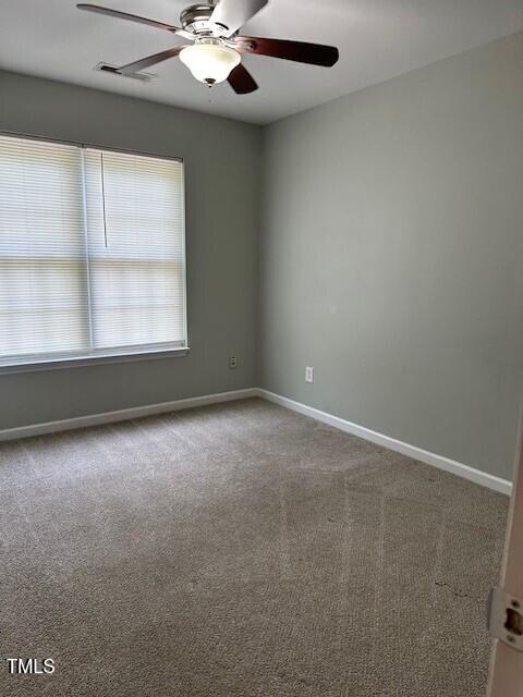 carpeted empty room with ceiling fan