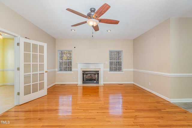 unfurnished living room featuring ceiling fan and light hardwood / wood-style floors