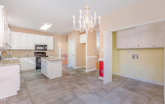 kitchen featuring white cabinetry, a center island, pendant lighting, and black appliances